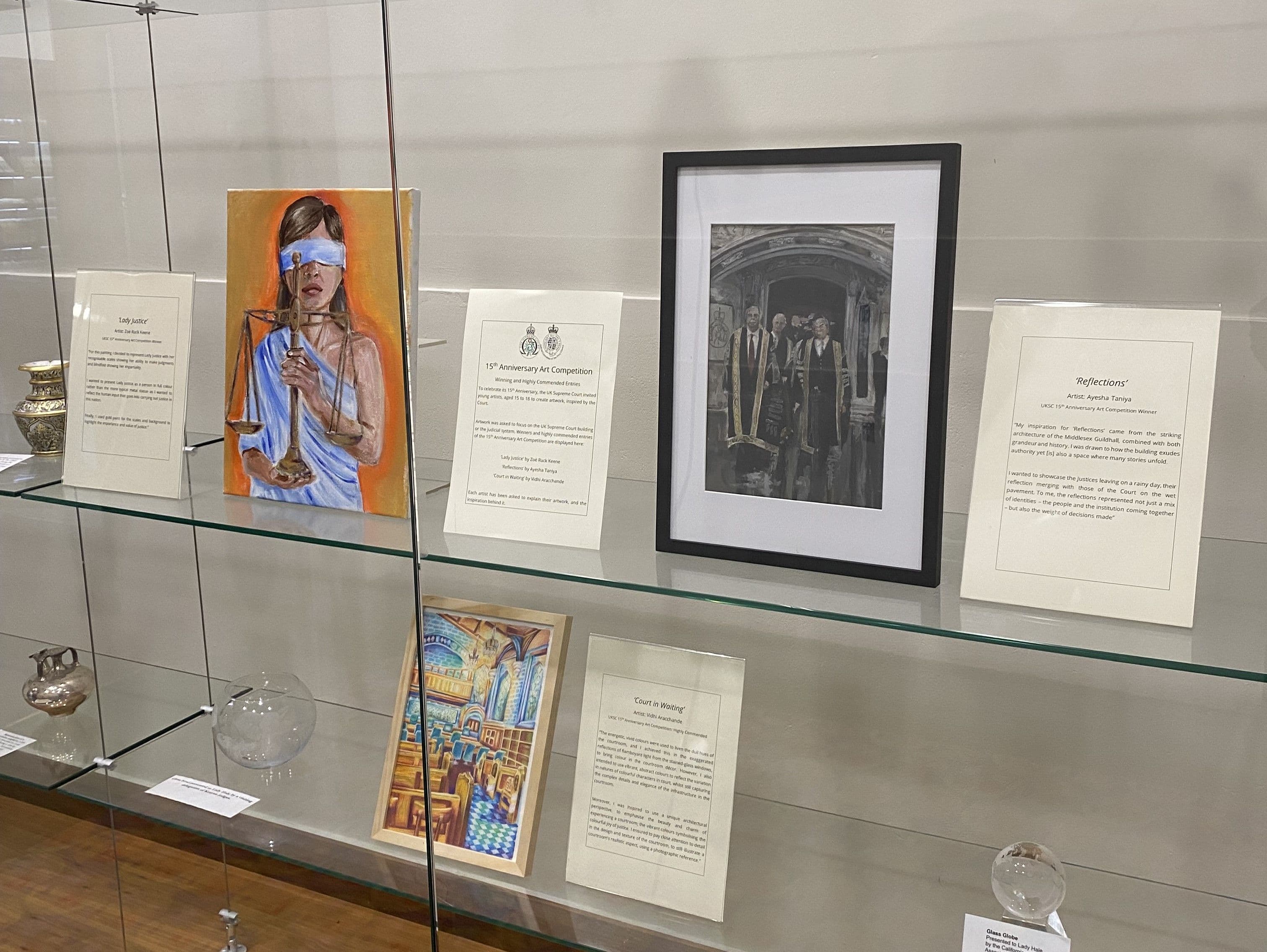 ‘Lady Justice’, ‘Reflections’ and ‘Court in Waiting’ in the exhibition at the UK Supreme Court. Next to each piece, the artist explains their inspiration.